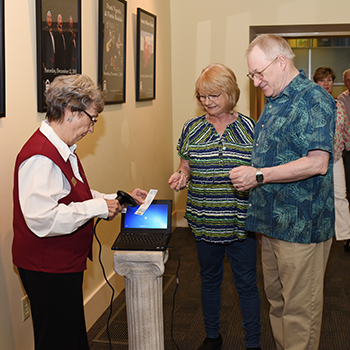 Clayton Center volunteer scanning a ticket