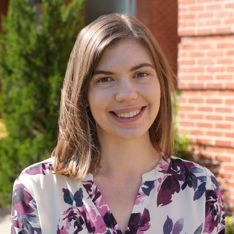 Haley Downey poses for photo in front of Clayton town tall