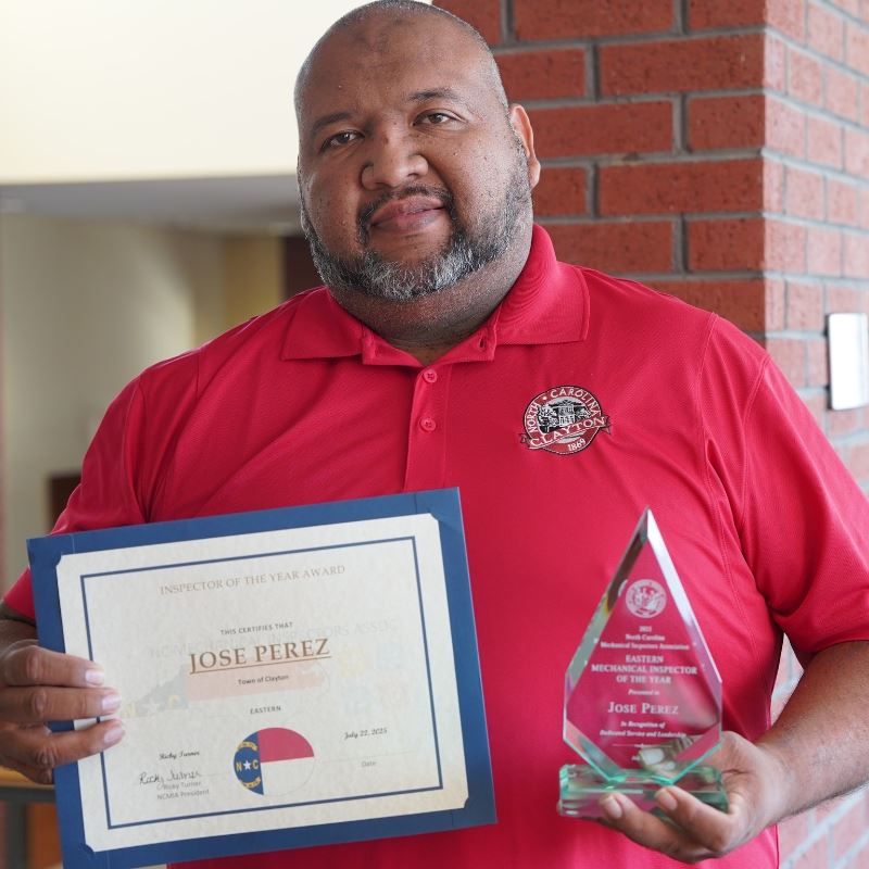 Jose Perez, inspector of the year holds awards