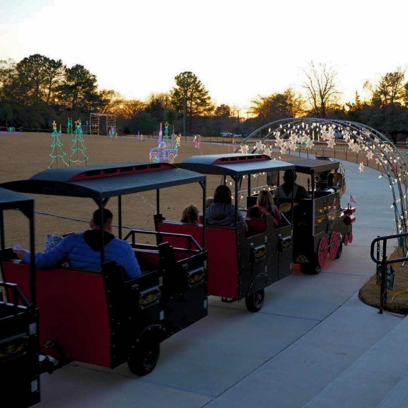 Families ride train through Municapal Park during Merry Municipal Express